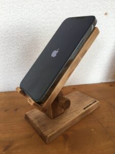 木製角度調整スマホスタンドにiphoneが載っている、ゆるい角度